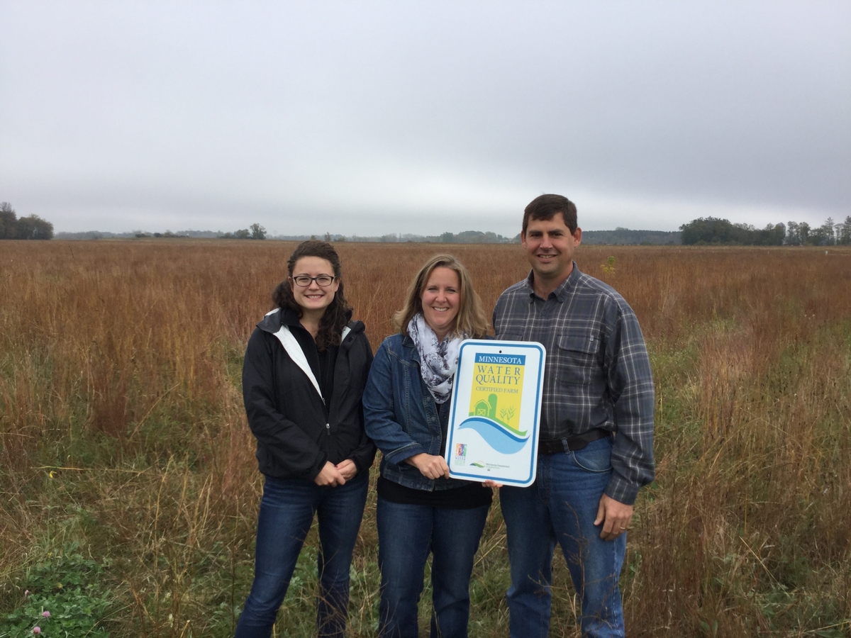 Photo of presentation of sign to landowners.