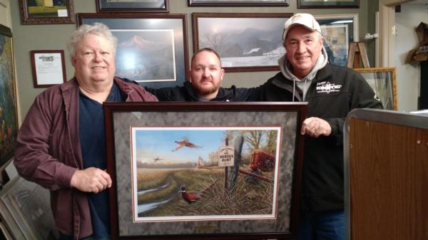 Gunnery Sgt Russo is presented with a Linn County PF Heroes Hunt print